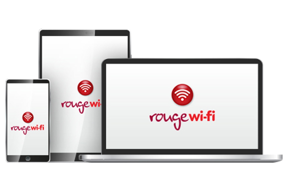 A laptop, tablet, and smartphone featuring Air Canada Rouge Wi-fi.